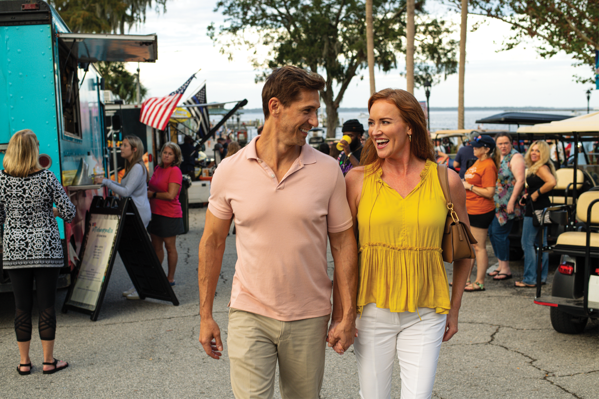 Couple walking in front of food trucks at Spring Park