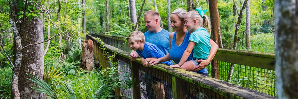 Family looking over bridge in Camp Chowenwaw