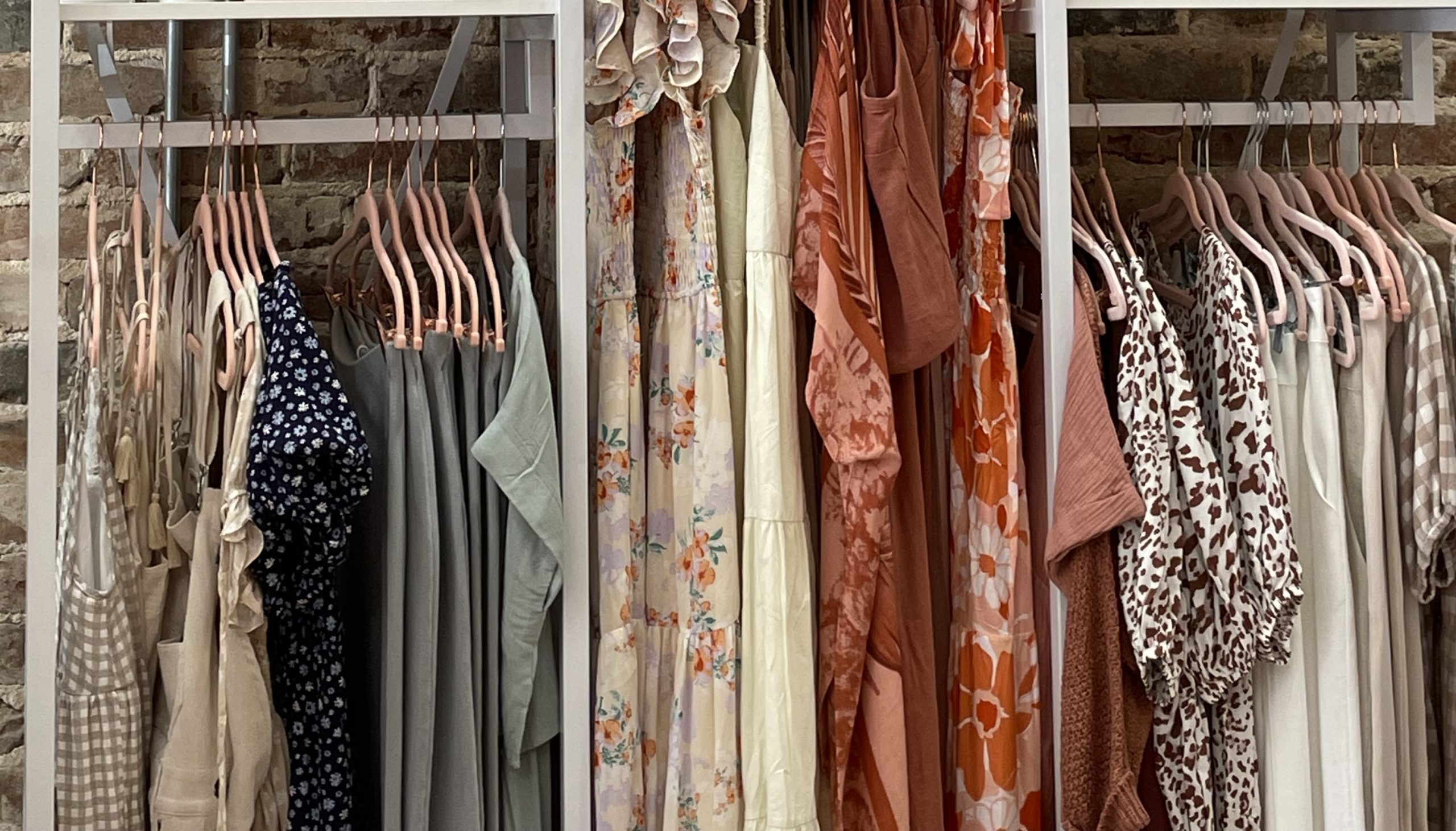Close up of rack of hanging clothing.