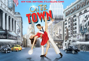 Couple dancing in front of downtown buildings.
