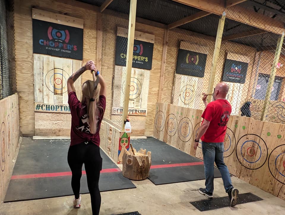 Live by the Axe photo of customers throwing axes indoors on the range