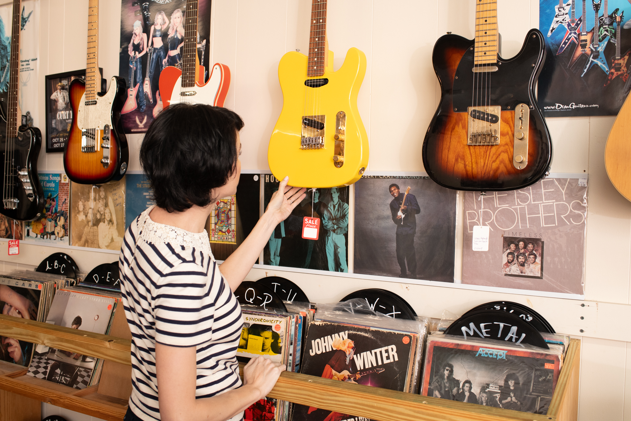 Woman looking at guitar at Guitar Station