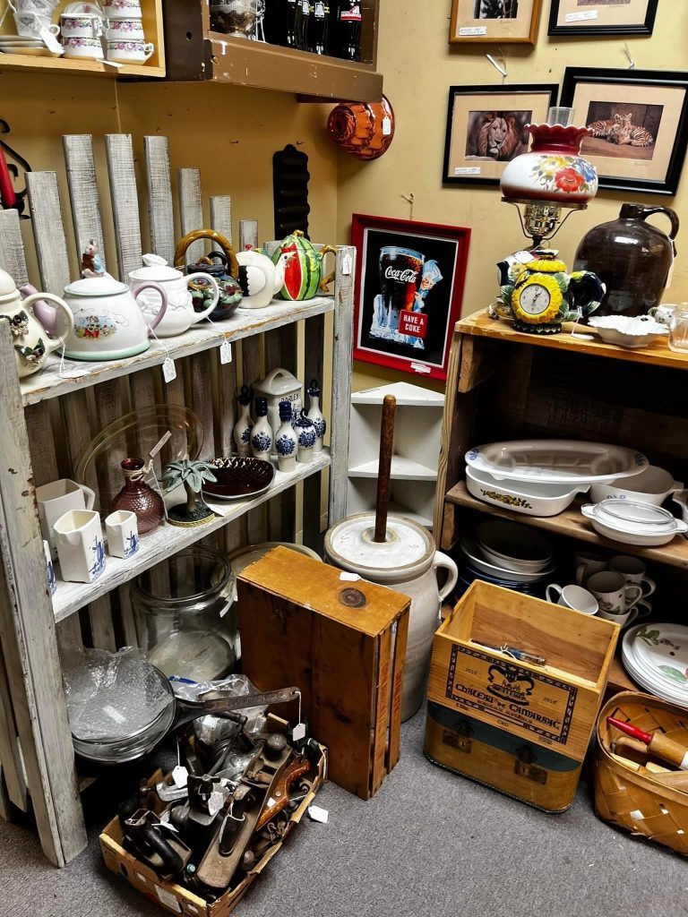 assortment of antique and vintage items including a tea pot, lamp, home decor, and more trinkets
