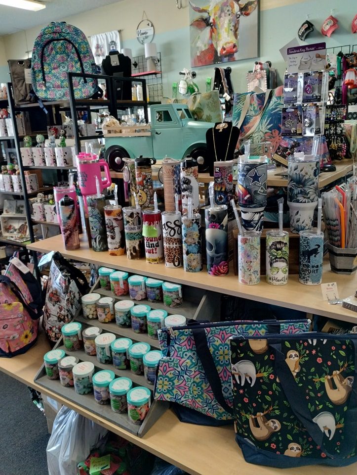 merchandise display at miss priss gifts of tumblers and candles and more