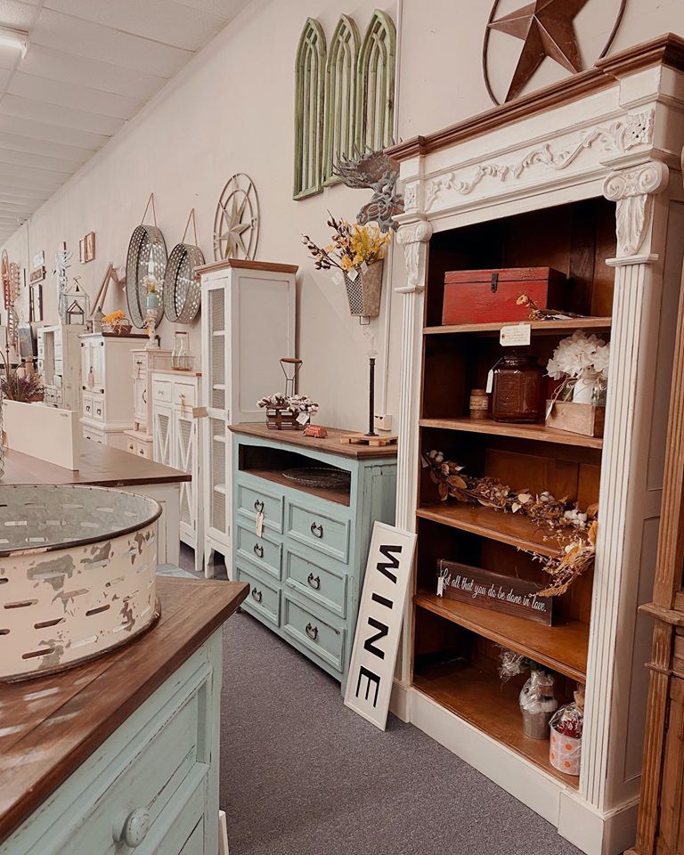 Bookcase and dresser shabby chic painted furniture store display with home decor on the shelves