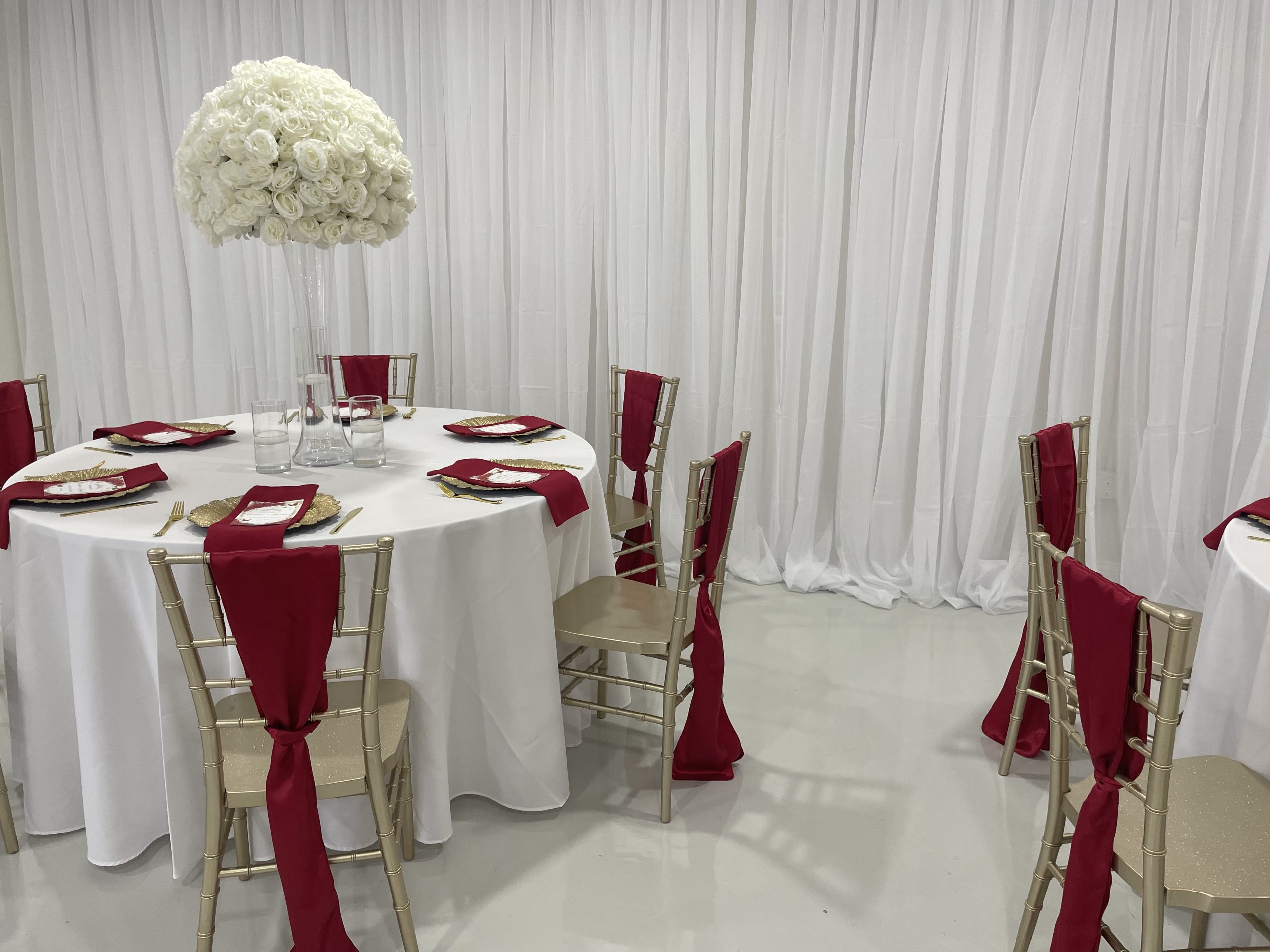 elegant table set for a wedding with large floral centerpiece