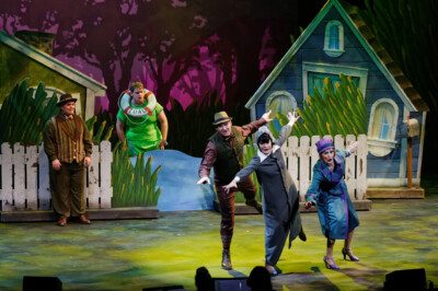 Actors performing play on stage.