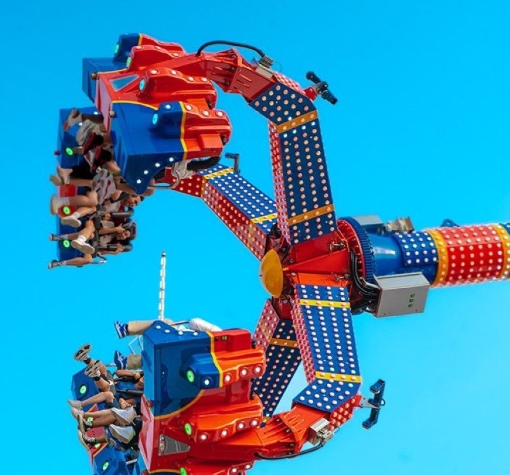 Photo of a carnival ride with multiple riders.