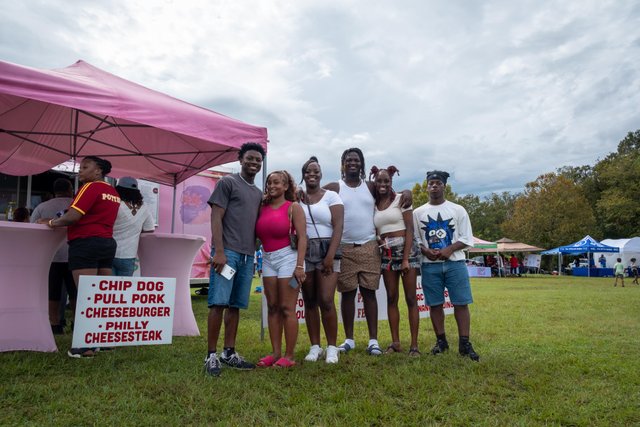 Soul-Food-Festival-2024-(2)-small Group of festival attendees posing in front of a pink food truck