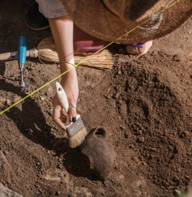 Ancient Colors Featured Photo Photo of a person uncovering ancient pottery and brushing off the dirt.